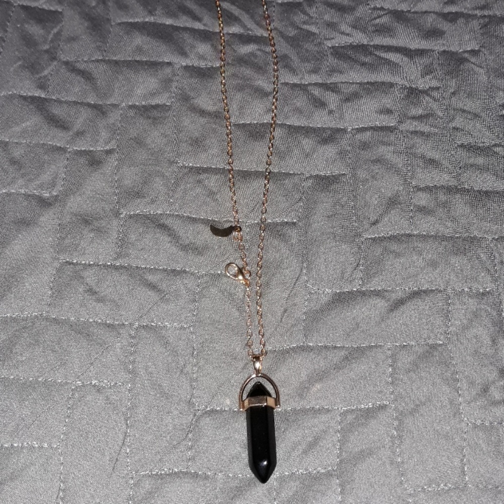 Gold costume necklace with black gem
